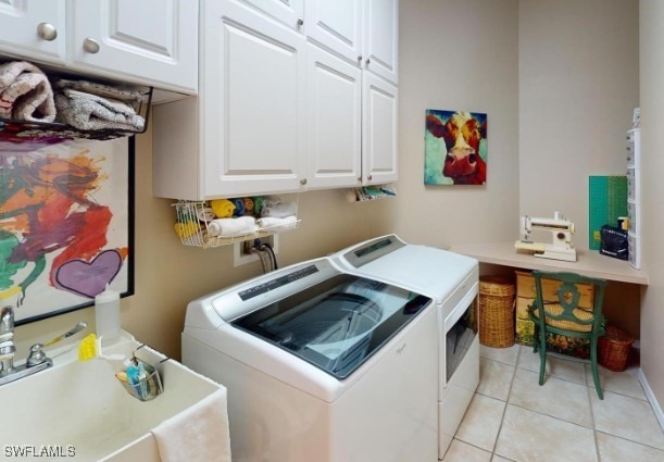 5291 Laurel Oak Ct, North Port, FL 34287 - washroom with a sink, cabinet space, light tile patterned flooring, and washer and dryer
