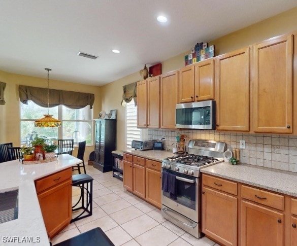 5291 Laurel Oak Ct, North Port, FL 34287 - kitchen featuring light countertops, stainless steel appliances, visible vents, and tasteful backsplash