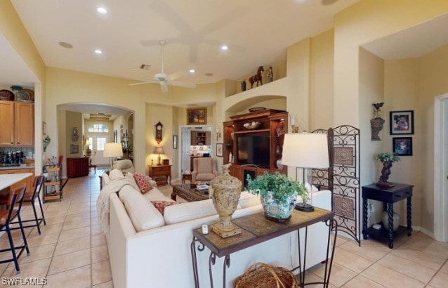 living room with light tile patterned flooring and ceiling fan