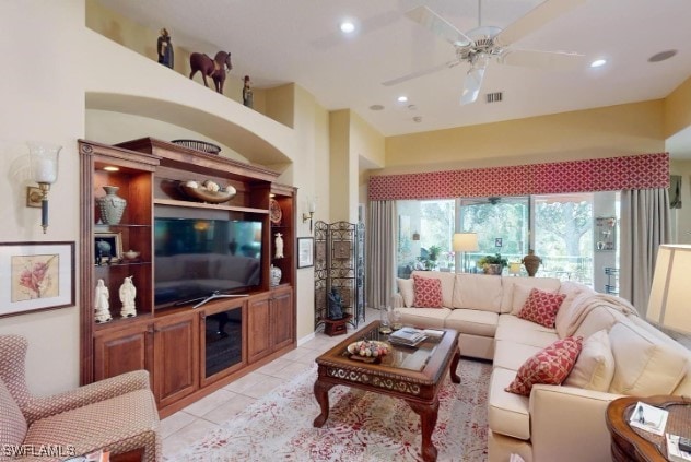 living room with ceiling fan and light tile patterned flooring