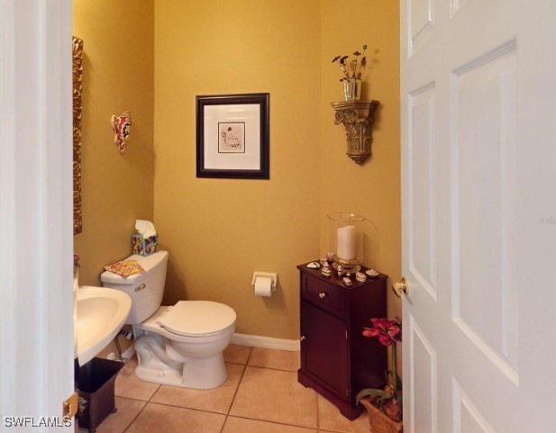 5291 Laurel Oak Ct, North Port, FL 34287 - bathroom with toilet, tile patterned floors, and baseboards