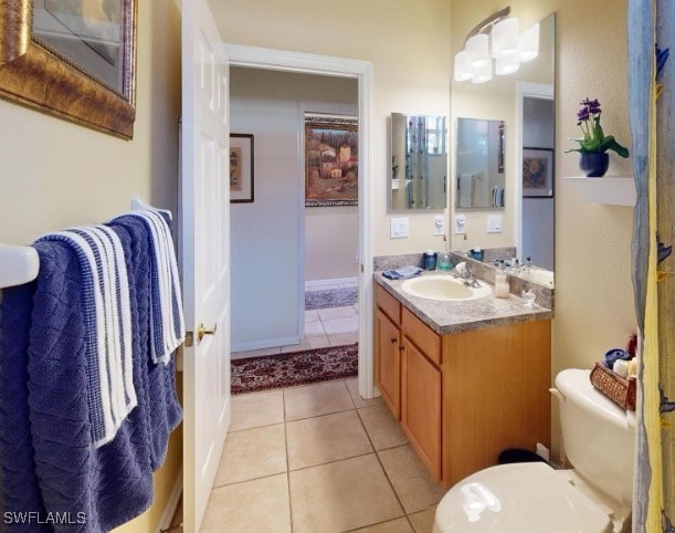 bathroom with vanity, toilet, and tile patterned floors