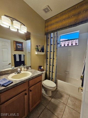 5291 Laurel Oak Ct, North Port, FL 34287 - full bath featuring vanity, toilet, tile patterned floors, shower / bathtub combination with curtain, and visible vents