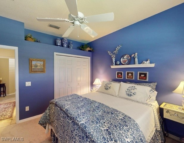 5291 Laurel Oak Ct, North Port, FL 34287 - bedroom with carpet floors, a ceiling fan, baseboards, visible vents, and a closet