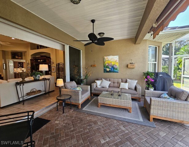 5291 Laurel Oak Ct, North Port, FL 34287 - view of patio / terrace featuring grilling area, ceiling fan, a lanai, and an outdoor hangout area