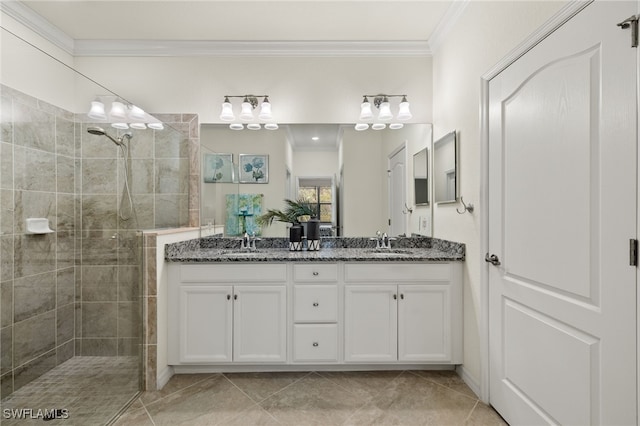 bathroom with vanity, crown molding, and tiled shower