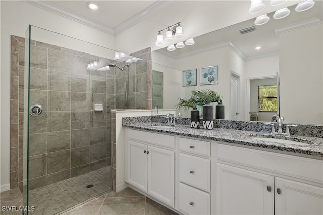 bathroom with vanity, crown molding, tile patterned floors, and tiled shower