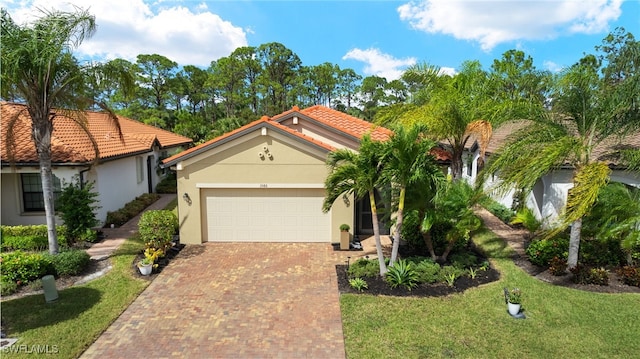 view of front of property featuring a garage and a front yard