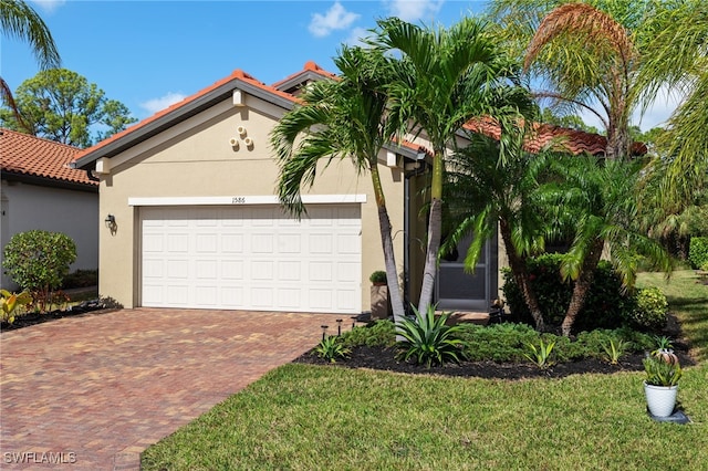 view of front facade with a garage and a front lawn