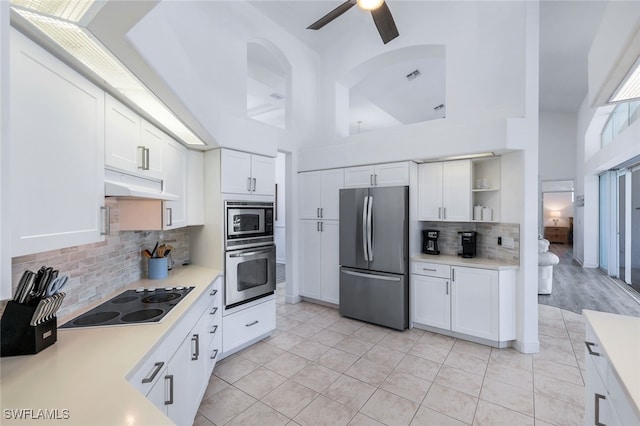 1524 SW 56th Ter, Cape Coral, FL 33914 - kitchen with tasteful backsplash, light countertops, under cabinet range hood, stainless steel appliances, and white cabinetry