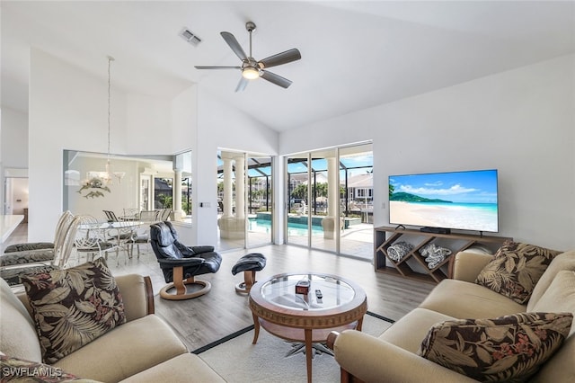 living room featuring high vaulted ceiling, light wood-type flooring, and ceiling fan