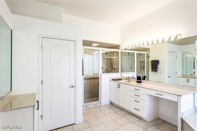 bathroom featuring vanity, tile patterned flooring, and a shower with door