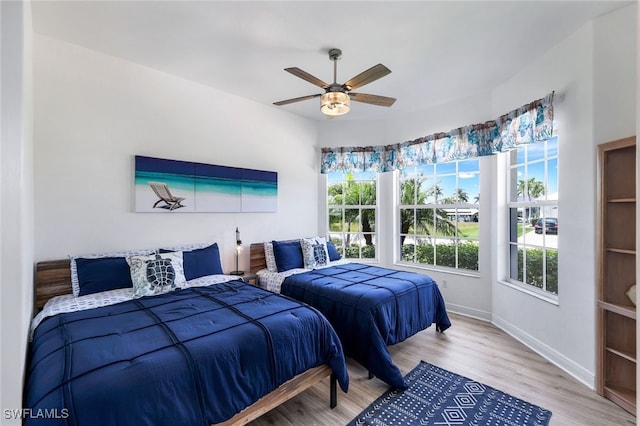 1524 SW 56th Ter, Cape Coral, FL 33914 - bedroom featuring baseboards, ceiling fan, and wood finished floors