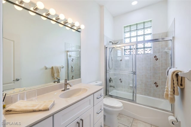 full bathroom with vanity, shower / bath combination with glass door, toilet, and tile patterned floors