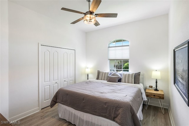 bedroom with a closet, hardwood / wood-style floors, and ceiling fan