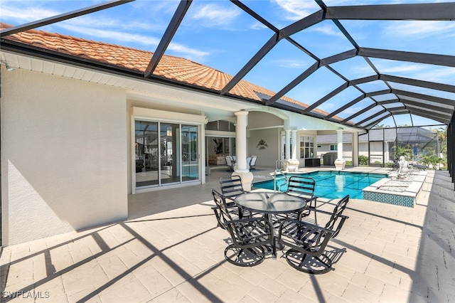 view of pool featuring a patio and glass enclosure