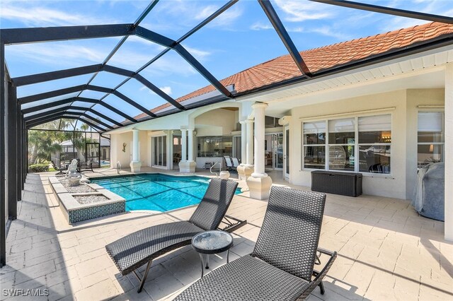 view of pool with a patio area and a lanai