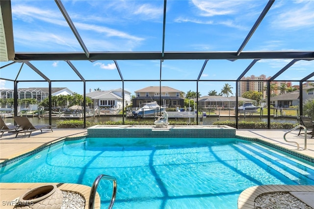 view of swimming pool featuring a water view, a patio, and a lanai