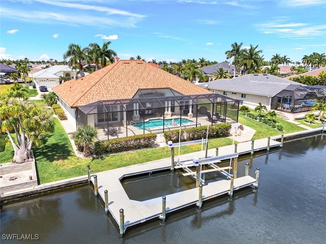 view of dock featuring a water view, a patio area, glass enclosure, and a lawn