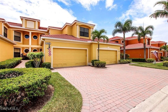 15801 Prentiss Pointe Cir Unit 102, Fort Myers, FL 33908 - mediterranean / spanish home with stucco siding, driveway, an attached garage, and a tile roof