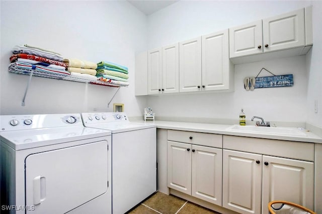 15801 Prentiss Pointe Cir Unit 102, Fort Myers, FL 33908 - washroom featuring washing machine and clothes dryer, cabinet space, and tile patterned flooring