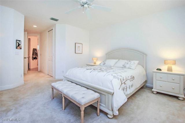 bedroom featuring ceiling fan, a closet, and light carpet