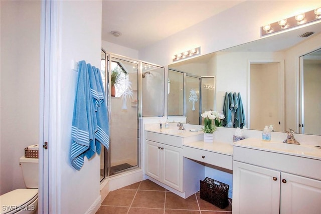 15801 Prentiss Pointe Cir Unit 102, Fort Myers, FL 33908 - full bathroom with double vanity, a shower stall, toilet, and tile patterned flooring