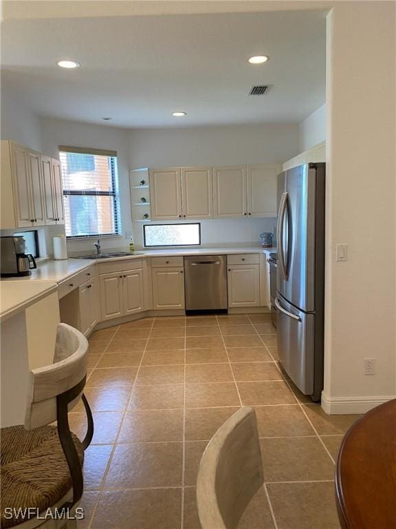 15801 Prentiss Pointe Cir Unit 102, Fort Myers, FL 33908 - kitchen featuring appliances with stainless steel finishes, light countertops, a sink, recessed lighting, and light tile patterned floors
