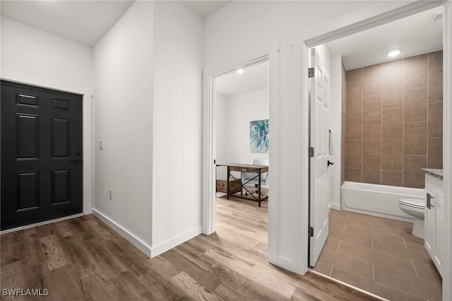 entryway with hardwood / wood-style flooring