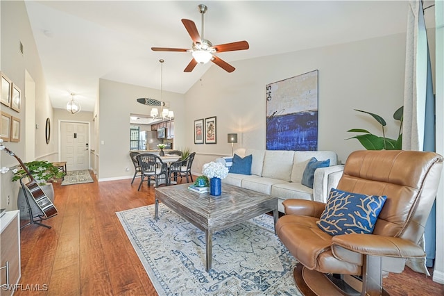 living room with ceiling fan, lofted ceiling, and hardwood / wood-style floors