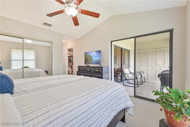 carpeted bedroom with multiple closets, vaulted ceiling, and ceiling fan