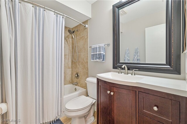 full bathroom with vanity, shower / bath combo with shower curtain, and toilet