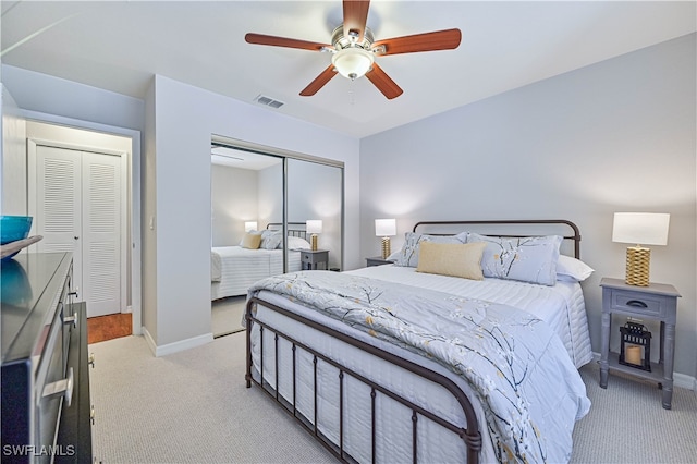 carpeted bedroom featuring a closet and ceiling fan