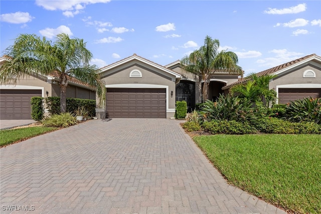 single story home with a front yard and a garage