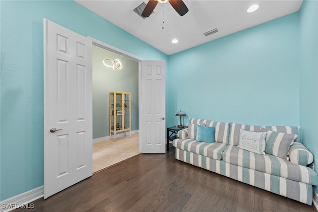 living room with dark wood-type flooring and ceiling fan