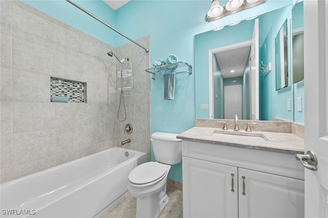 full bathroom featuring tiled shower / bath, vanity, toilet, and tile patterned floors