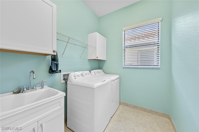 washroom featuring sink, light tile patterned floors, cabinets, and washer and clothes dryer