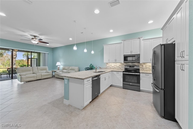 kitchen featuring white cabinetry, appliances with stainless steel finishes, decorative light fixtures, and kitchen peninsula