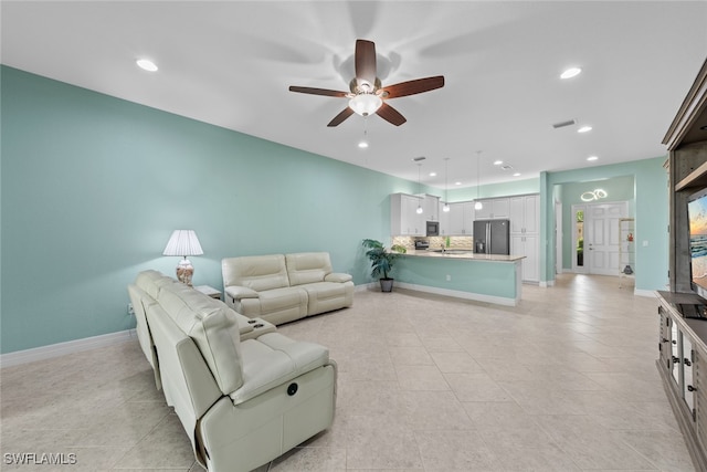 tiled living room with ceiling fan