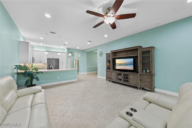 tiled living room featuring ceiling fan