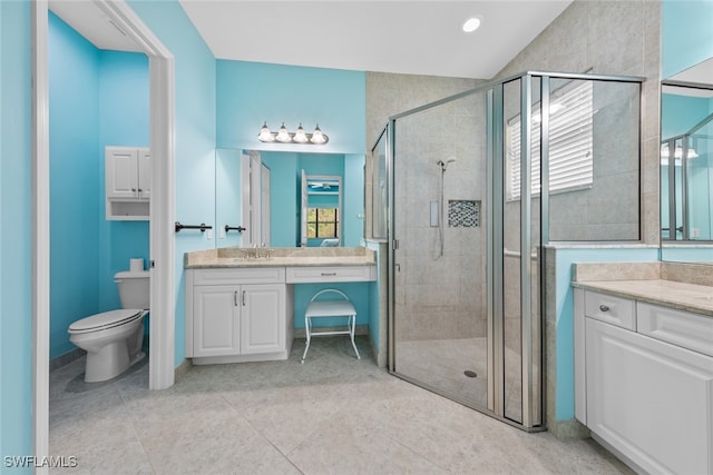 bathroom with vanity, tile patterned flooring, toilet, and an enclosed shower