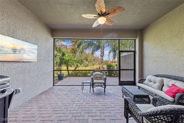 sunroom / solarium featuring ceiling fan