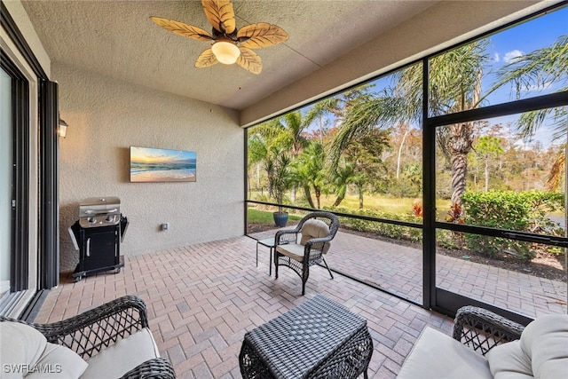 sunroom featuring ceiling fan