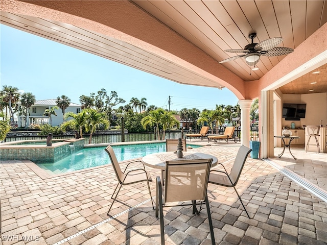 view of swimming pool featuring an in ground hot tub, ceiling fan, and a patio