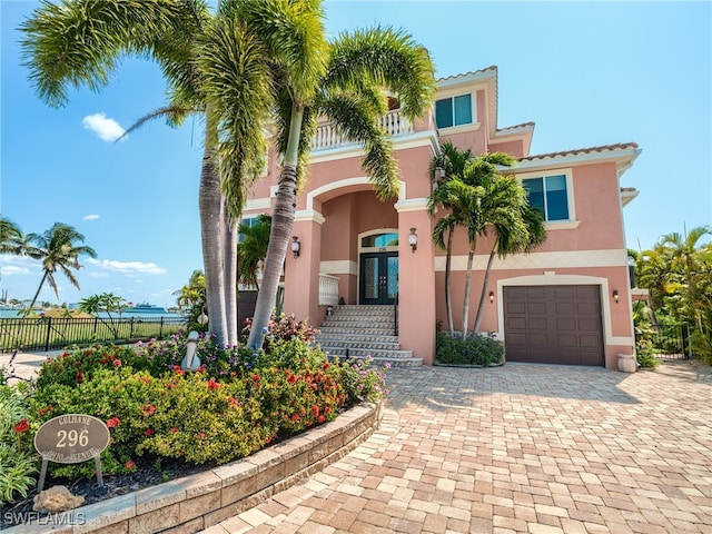 mediterranean / spanish-style home with french doors and a garage