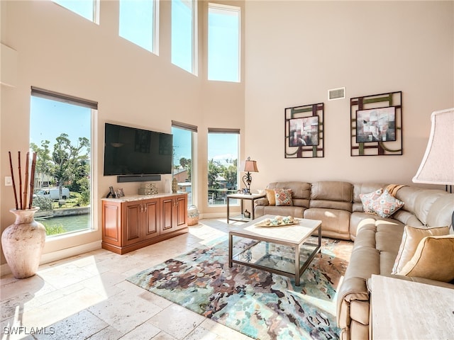 living room featuring a towering ceiling