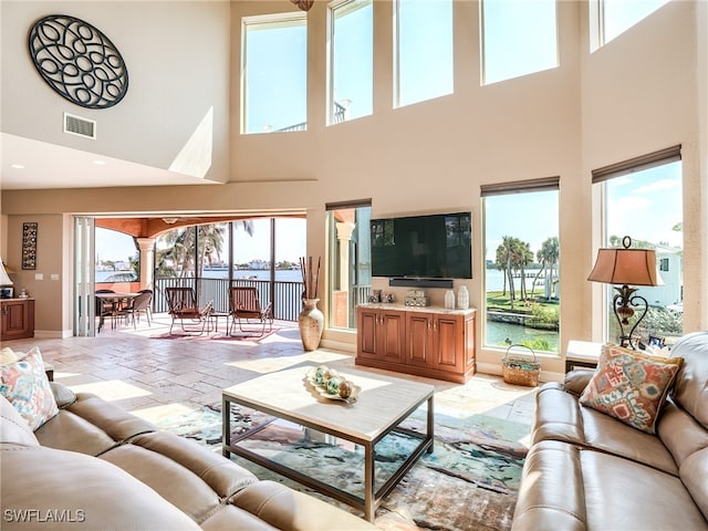 living room featuring a towering ceiling