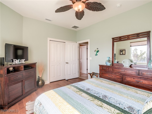 bedroom featuring ceiling fan, a closet, and light wood-type flooring