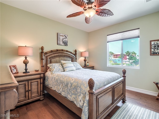 bedroom with ceiling fan and dark wood-type flooring