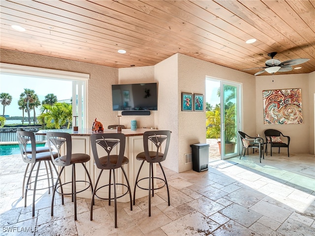 bar with ceiling fan and wooden ceiling